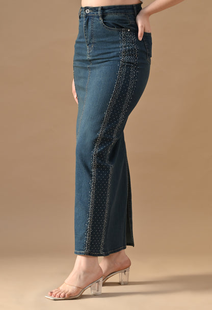 Blue jeans with decorative stitching on a beige background